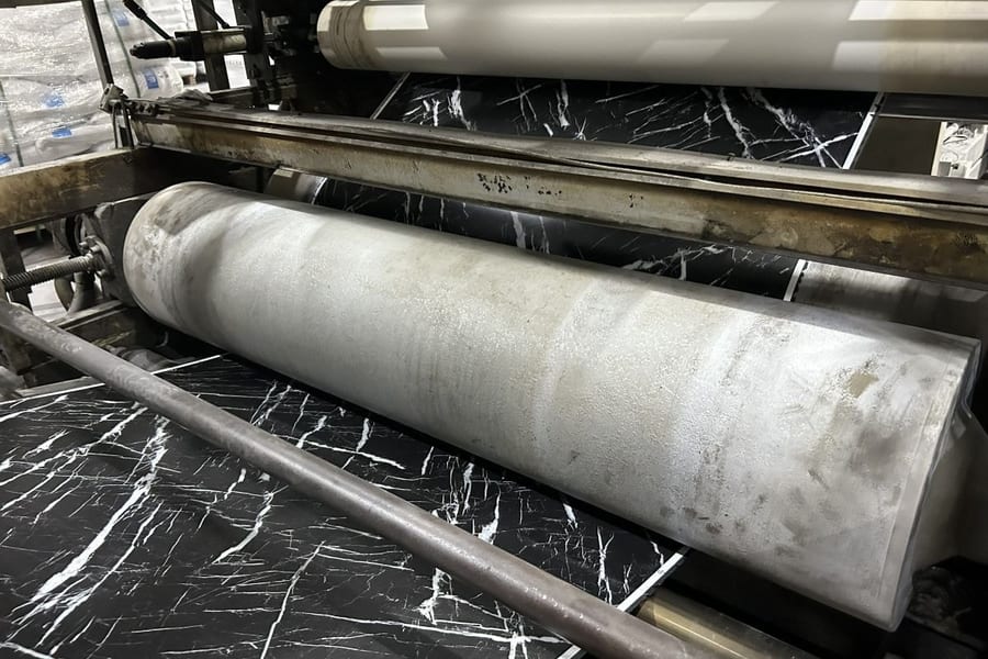Lamination press applying decorative film